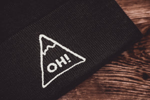 Close up of white embroidered triangle with OH! lettering on Black Beanie