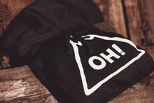 Close up of black hoodie with hood folded over. Oversized white chest print with OH! lettering